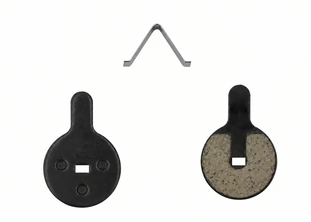Two round black target discs with a square cutout, one showing the back with three screw holes and one showing the front with a textured insert, plus a small V-shaped metal clip at the top on a white background.